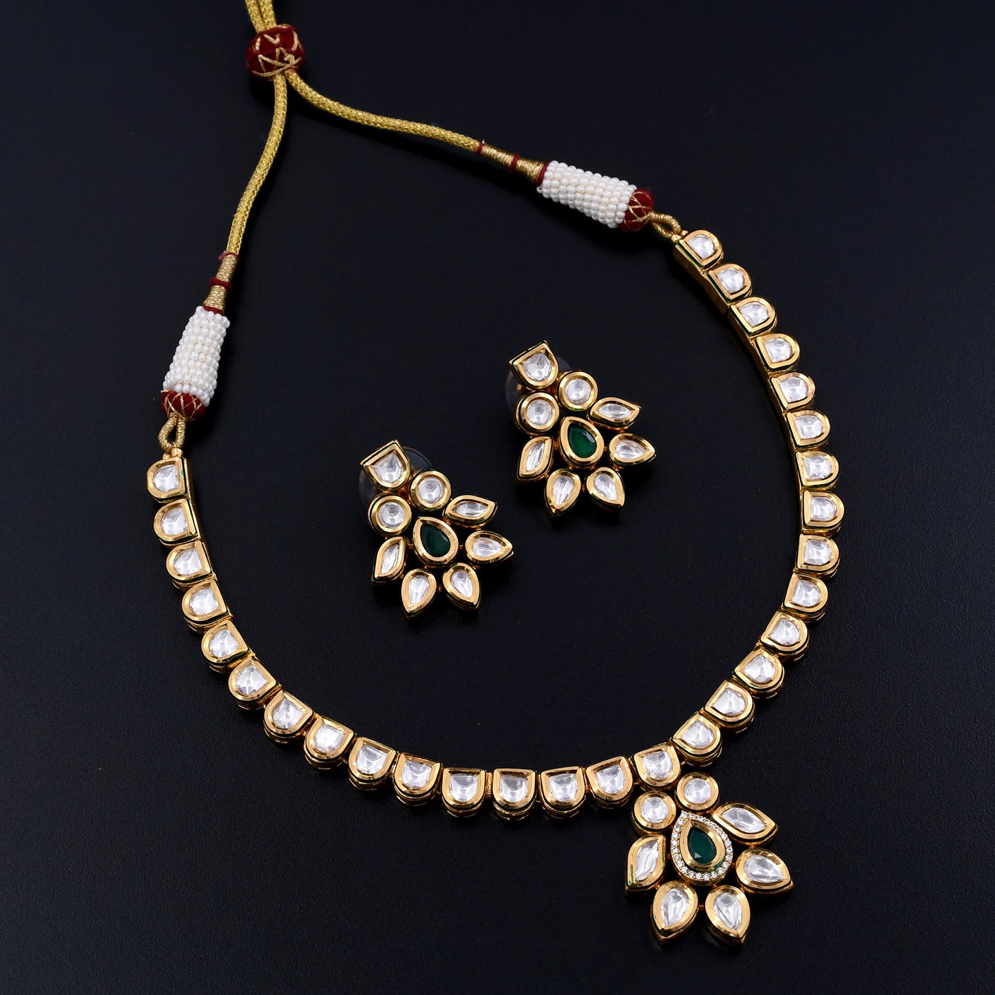 Leela | Emerald Elegance Polki Necklace Set with Gleaming Gold Polish and Radiant Green Centerpiece, Complemented by Graceful Stud Earrings for Cultural Sophistication